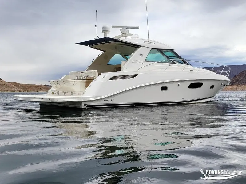 Slide: The Image of 2012 Sea Ray 450 Sundancer yacht on calm water. - 10