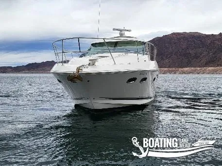 Slide: The Image of 2012 Sea Ray 450 Sundancer yacht on a lake with mountainous backdrop. - 11