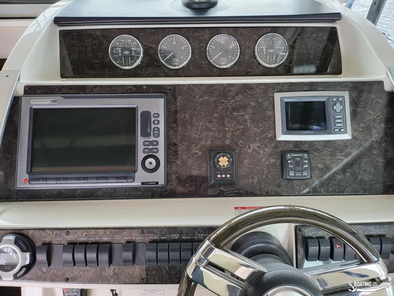 Slide: The Image of Control panel of a 2012 Sea Ray 450 Sundancer yacht with navigation instruments. - 13