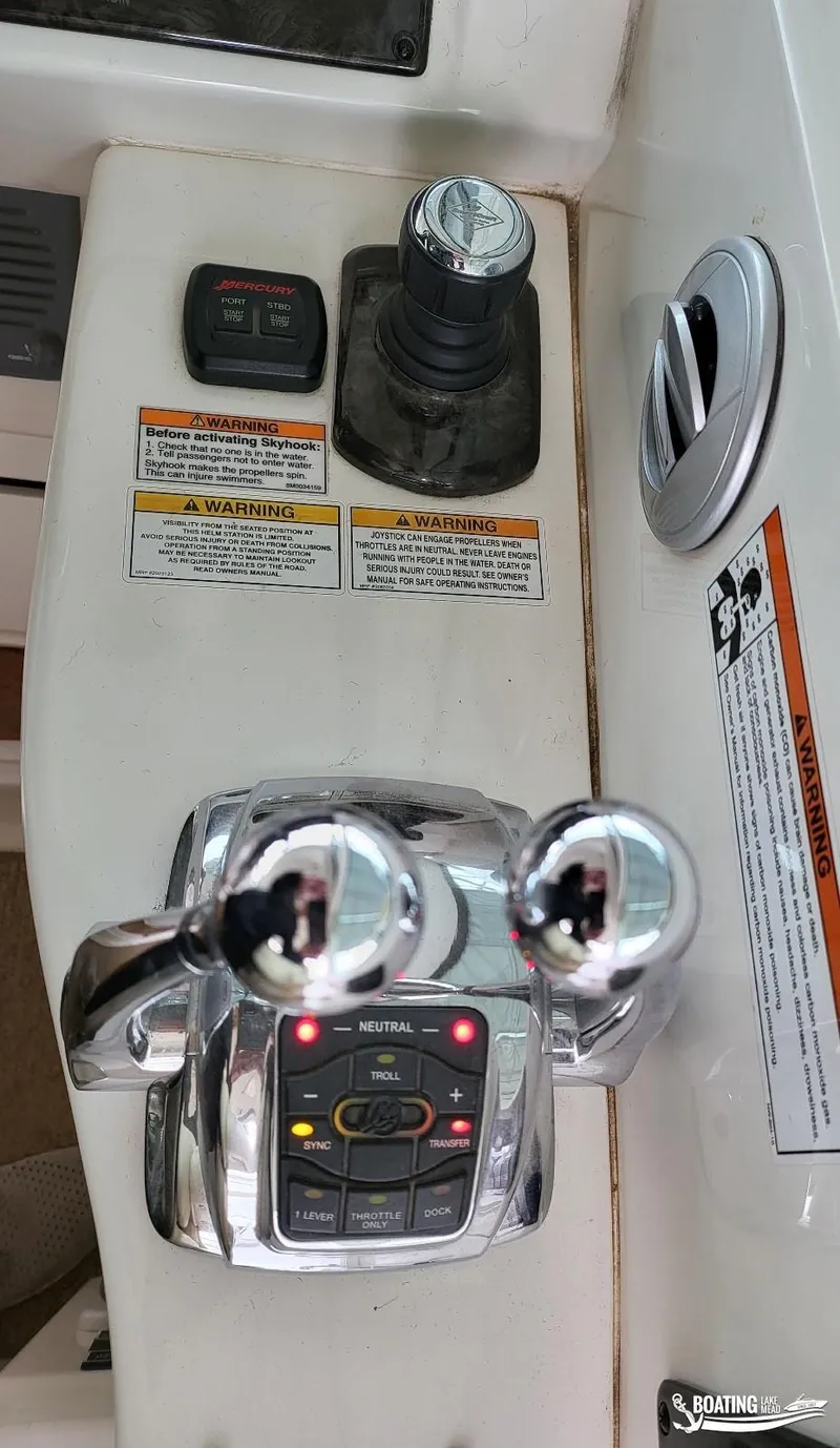 Slide: The Image of Control panel of a 2012 Sea Ray 450 Sundancer boat with throttle and joystick. - 16