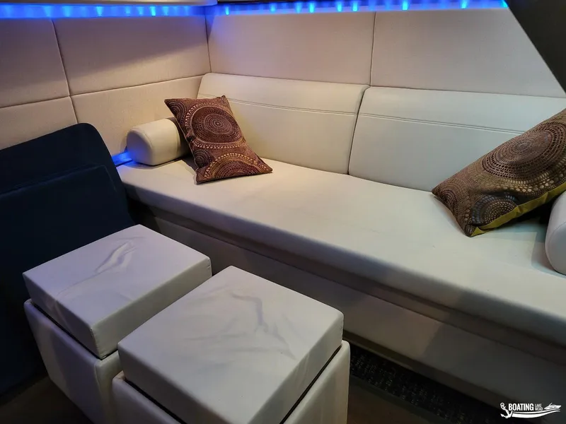 Slide: The Image of Interior of 2012 Sea Ray 450 Sundancer with white leather seating and decorative pillows. - 26