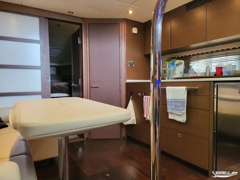Slide: The Image of Interior of 2012 Sea Ray 450 Sundancer yacht with modern kitchen and seating area. - 29