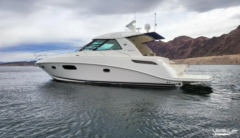 Slide: The Image of 2012 Sea Ray 450 Sundancer yacht on a lake with mountainous background. - 3