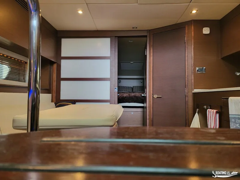 Slide: The Image of Interior of 2012 Sea Ray 450 Sundancer yacht with modern furnishings and cozy cabin. - 30