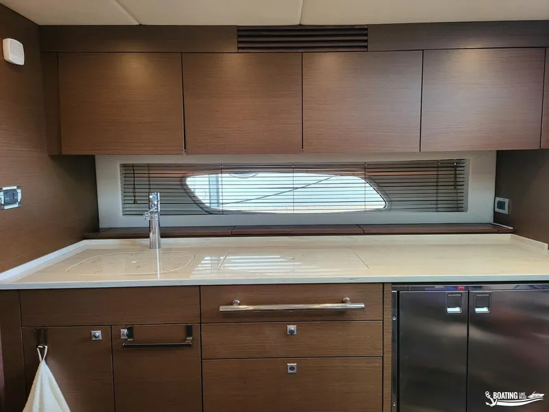 Slide: The Image of Modern kitchen area in 2012 Sea Ray 450 Sundancer yacht with sleek cabinetry. - 32