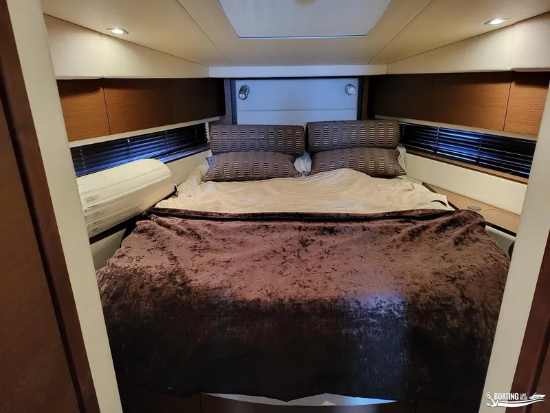 Slide: The Image of Luxurious bedroom interior of 2012 Sea Ray 450 Sundancer yacht with cozy bedding. - 33