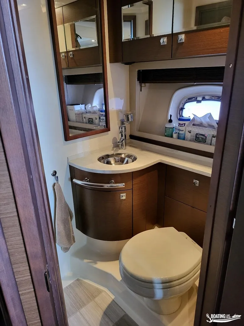 Slide: The Image of Modern bathroom in 2012 Sea Ray 450 Sundancer yacht with sink, toilet, and storage. - 34