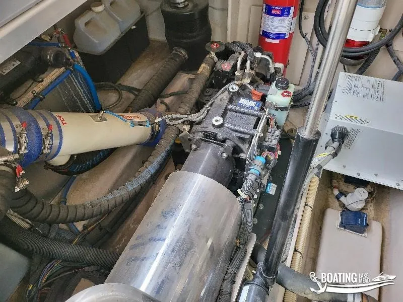Slide: The Image of Engine compartment of a 2012 Sea Ray 450 Sundancer boat with various mechanical components. - 39
