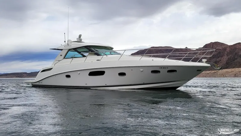 Slide: The Image of 2012 Sea Ray 450 Sundancer yacht on water with mountainous background. - 4