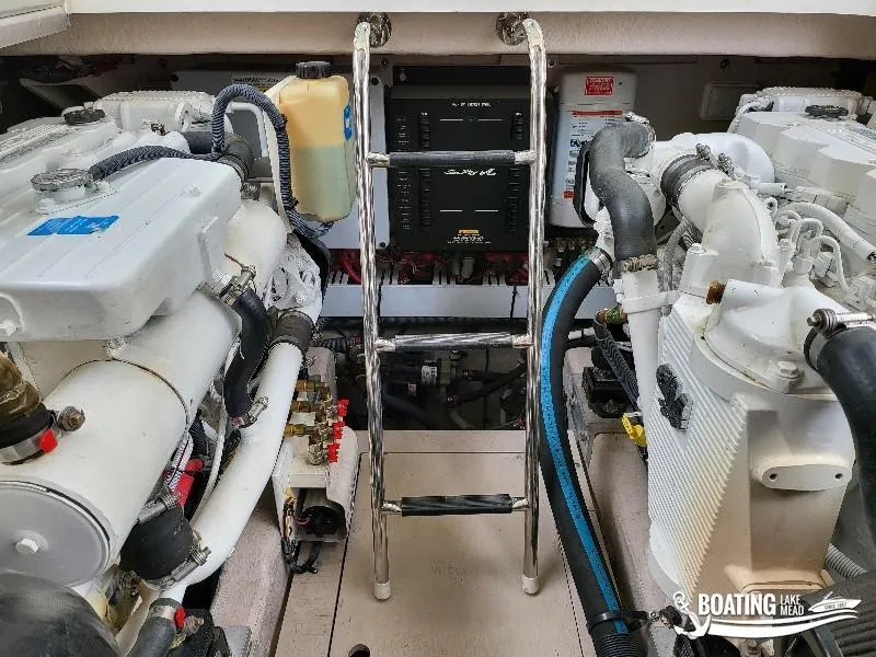 Slide: The Image of Engine room of a 2012 Sea Ray 450 Sundancer yacht with dual engines and ladder. - 41