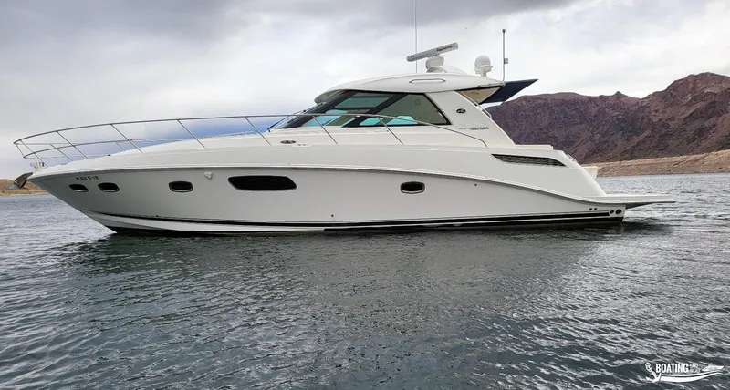 Slide: The Image of 2012 Sea Ray 450 Sundancer yacht on water with mountainous background. - 5