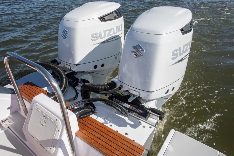 Slide: The Image of 2024 True North 34 boat with dual Suzuki outboard engines on water. - 14