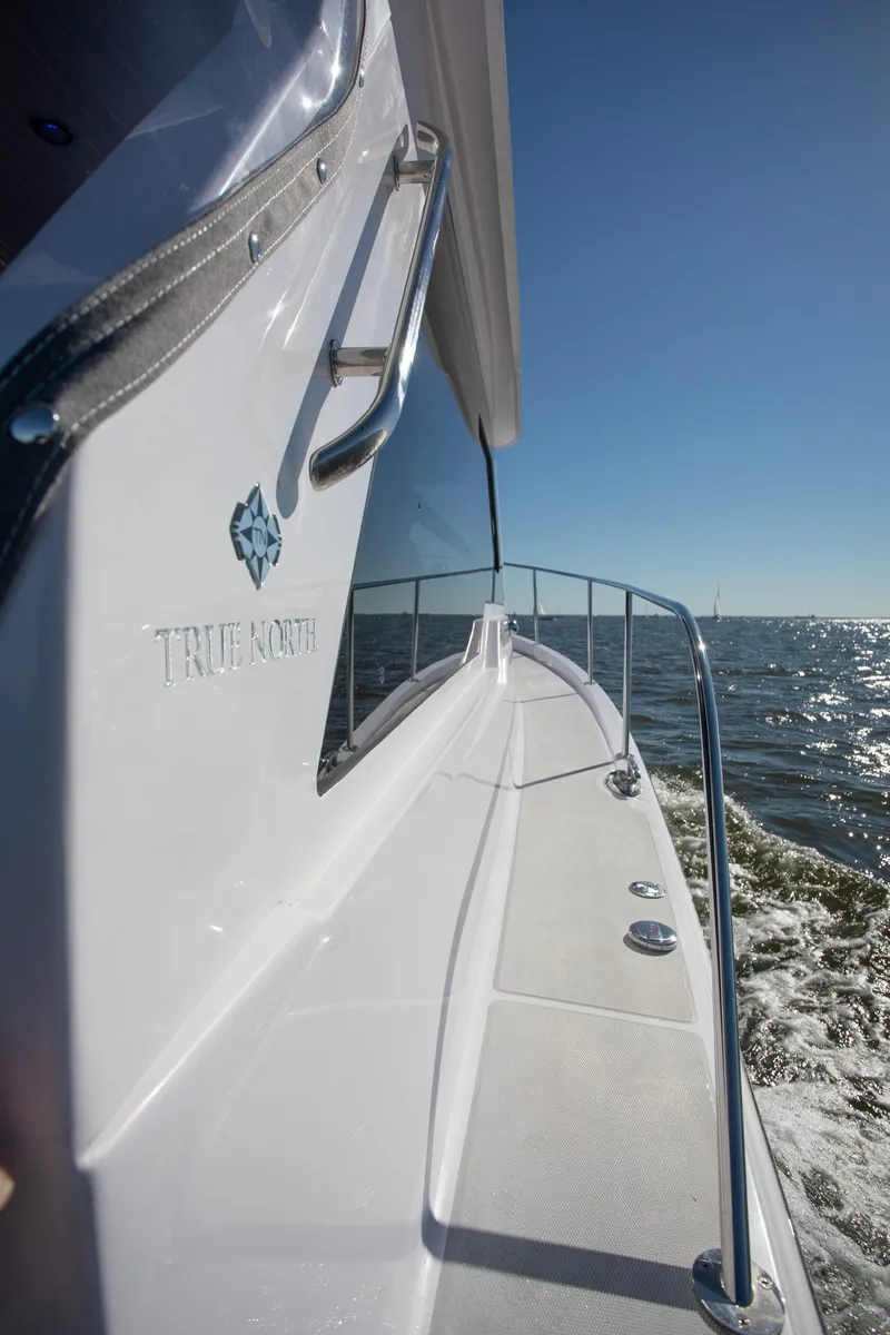 Slide: The Image of 2024 True North 34 boat cruising on open water. - 16