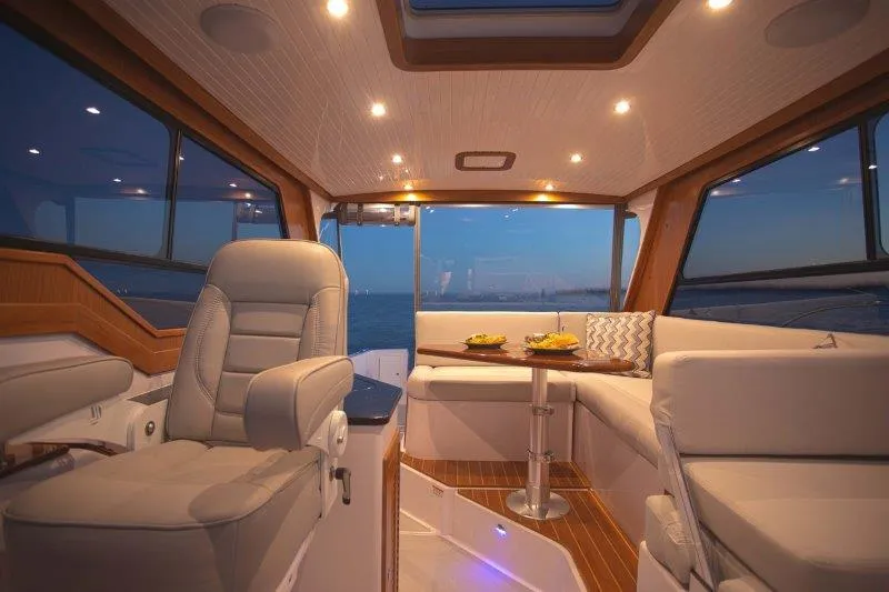 Slide: The Image of Luxurious interior of the 2024 True North 34 yacht with elegant seating and dining area. - 4