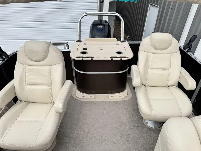 Slide: The Image of 2018 Starcraft 23 FD boat interior with beige leather seats and control console. - 3