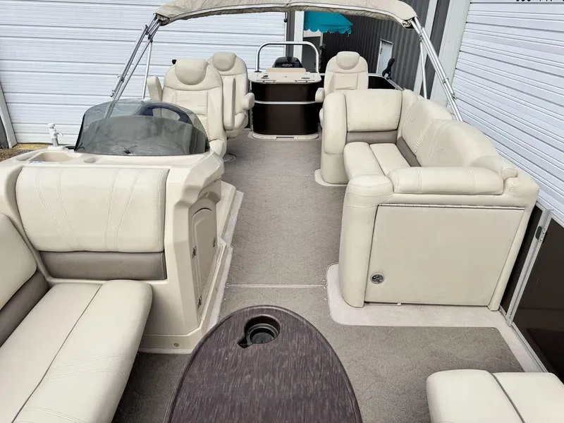 Slide: The Image of 2018 Starcraft 23 FD pontoon boat interior with beige seating and helm. - 6