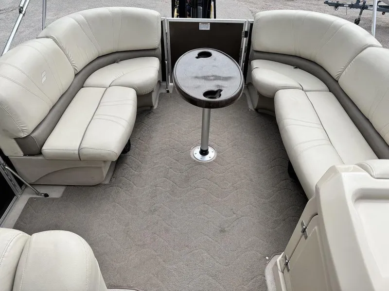 Slide: The Image of 2018 Starcraft 23 FD boat interior with beige seating and a central table. - 7
