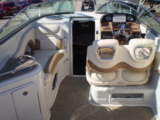 Slide: The Image of 2021 Crownline 264 CR boat interior with beige seating and Garmin navigation system. - 20