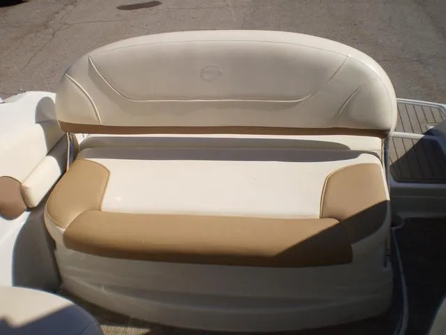 Slide: The Image of 2021 Crownline 264 CR boat seating area with beige and white upholstery. - 21