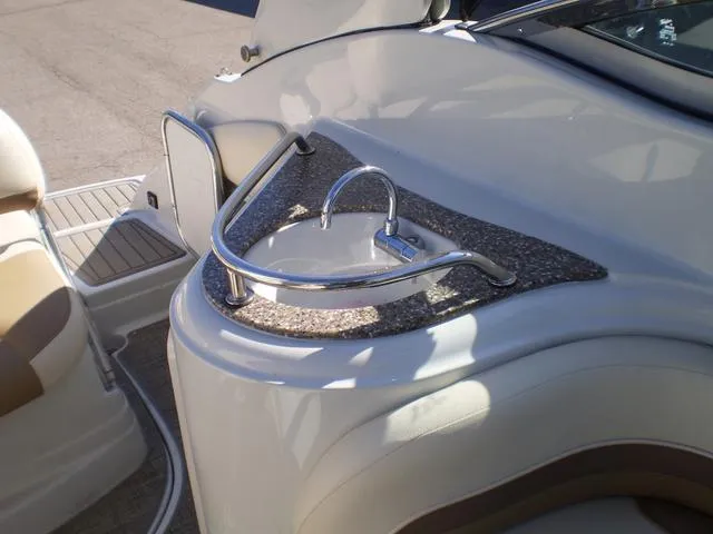 Slide: The Image of 2021 Crownline 264 CR boat interior with a built-in sink and countertop. - 22
