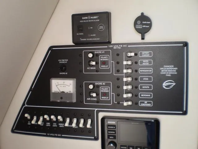 Slide: The Image of Control panel of a 2021 Crownline 264 CR boat with various switches and meters. - 31
