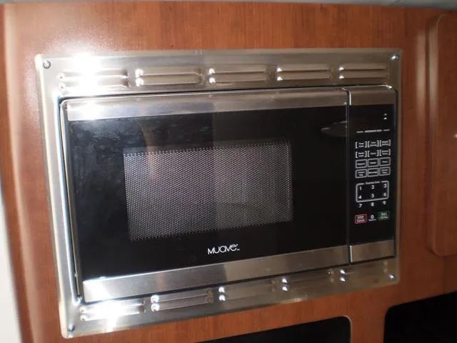 Slide: The Image of Built-in microwave in 2021 Crownline 264 CR boat kitchen. - 32