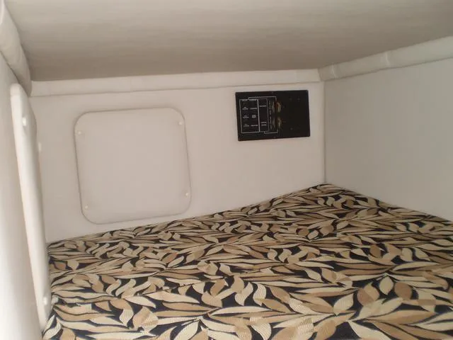 Slide: The Image of Interior cabin of 2021 Crownline 264 CR boat with patterned bedding. - 36