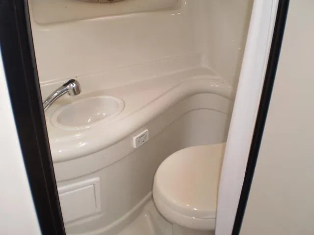 Slide: The Image of Compact bathroom in 2021 Crownline 264 CR boat with sink and toilet. - 38
