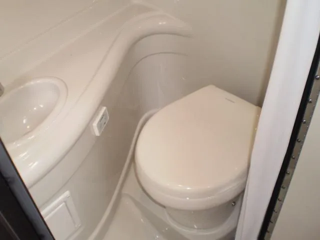 Slide: The Image of 2021 Crownline 264 CR boat bathroom with toilet and sink. - 40