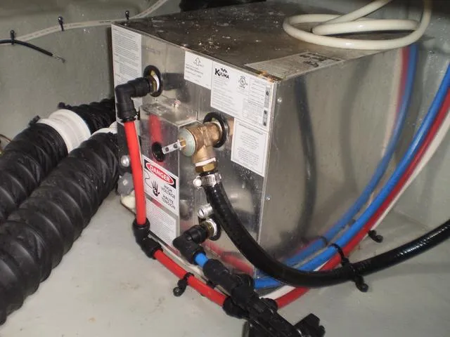 Slide: The Image of 2021 Crownline 264 CR boat engine compartment with water heater and hoses. - 43