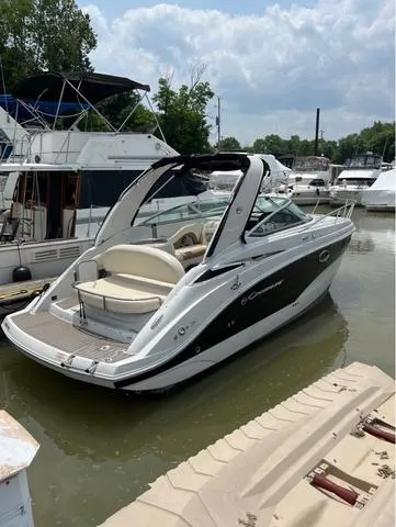 Slide: The Image of 2021 Crownline 264 CR boat docked in a marina, featuring sleek design and spacious seating. - 45