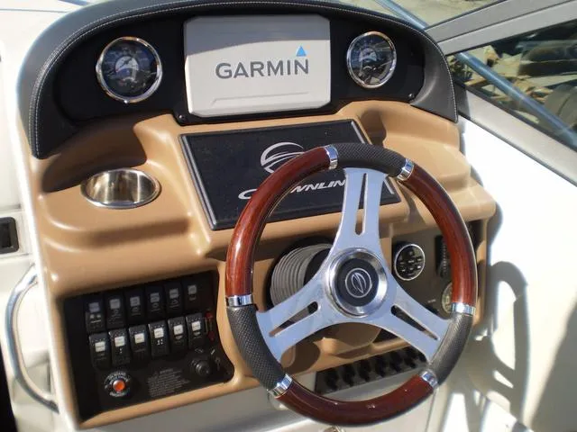 Slide: The Image of Crownline 264 CR 2021 boat dashboard with Garmin navigation system and steering wheel. - 9