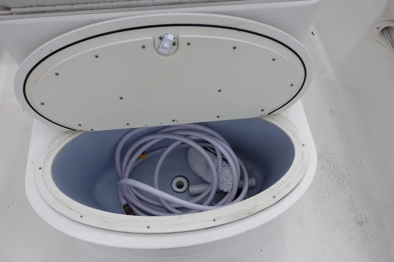 Slide: The Image of Open storage compartment on 2008 Trophy 1903 Center Console boat with coiled hose inside. - 11