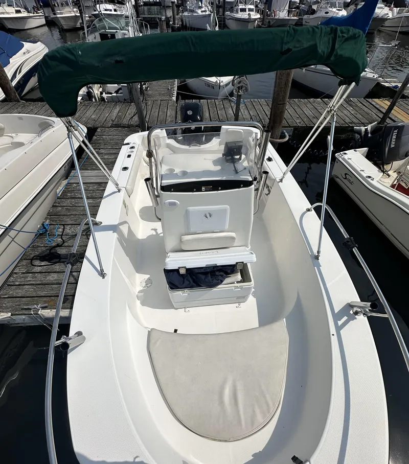Slide: The Image of 2008 Trophy 1903 Center Console boat docked at marina, featuring green canopy. - 2