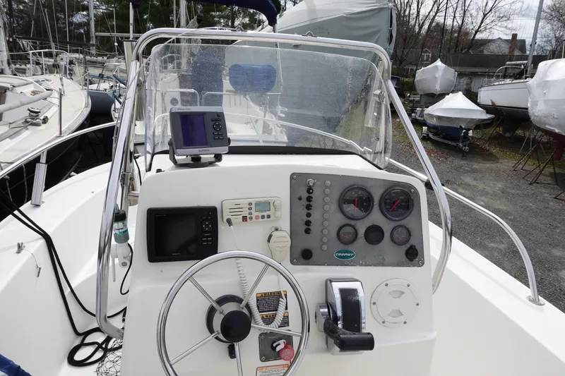 Slide: The Image of 2008 Trophy 1903 Center Console boat dashboard with steering wheel and navigation instruments. - 6