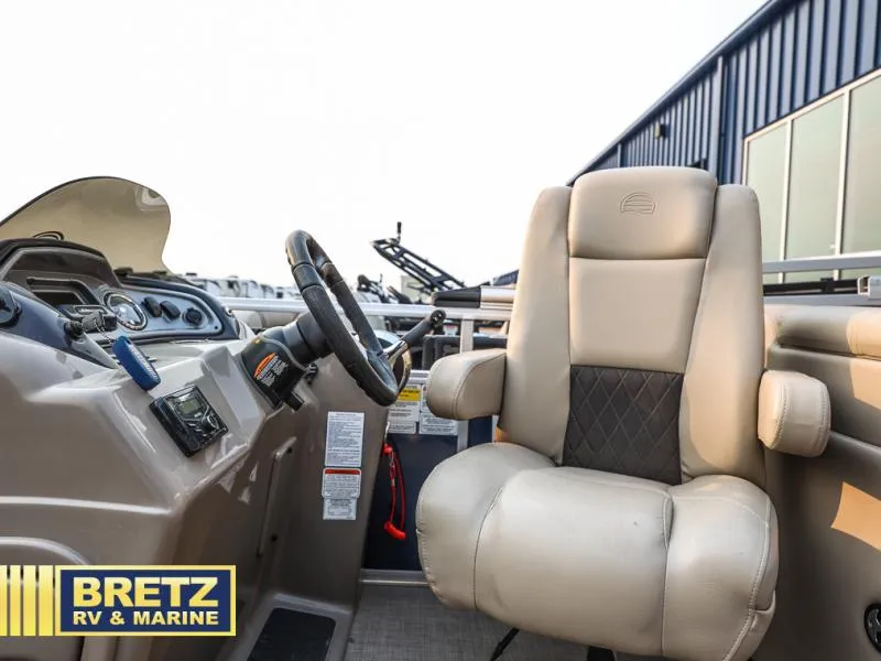 Slide: The Image of 2022 Tracker 22 XP3 Party Barge helm with beige captain's chair and control panel. - 11