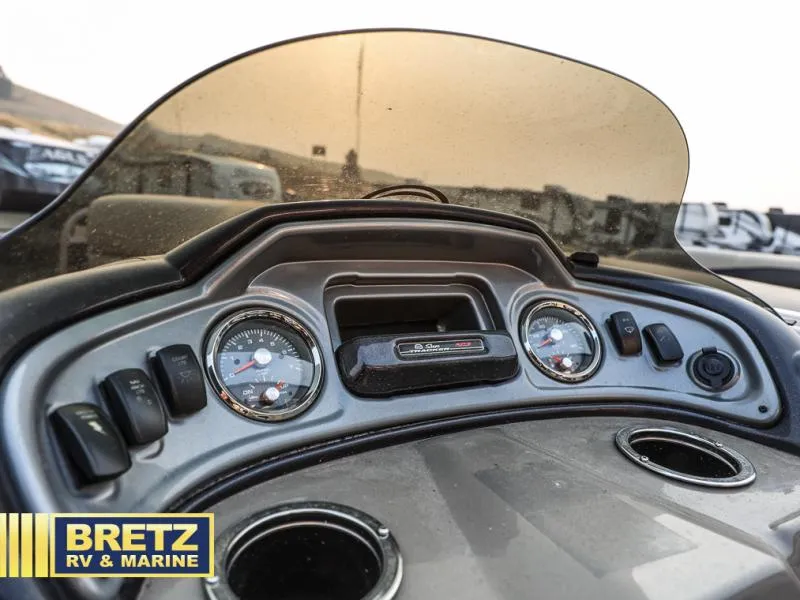 Slide: The Image of 2022 Tracker 22 XP3 PARTY BARGE dashboard with gauges and controls, Bretz RV & Marine logo. - 6