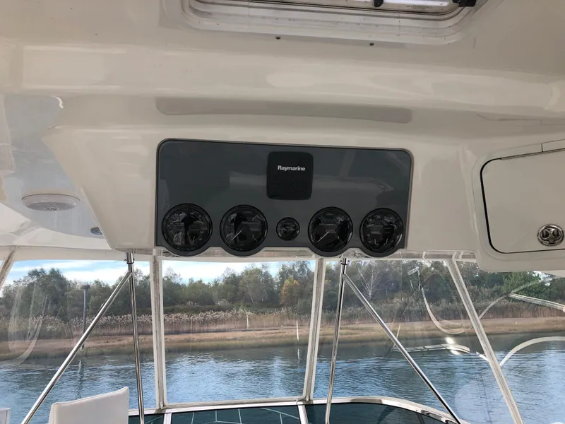 Slide: The Image of 2006 Sea Ray 52 Sedan Bridge helm with Raymarine electronics. - 11