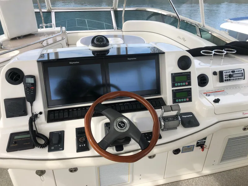 Slide: The Image of Helm of 2006 Sea Ray 52 Sedan Bridge with dual Raymarine displays and wooden steering wheel. - 13