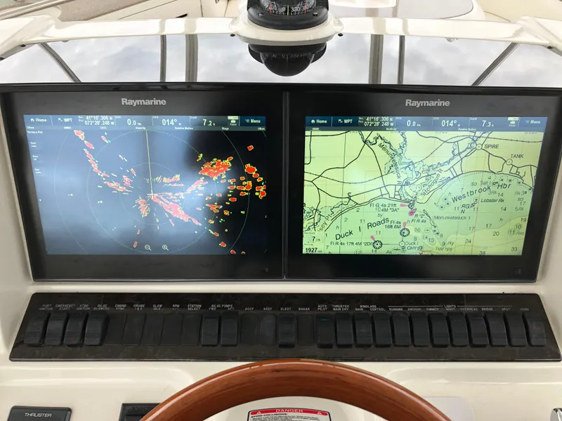 Slide: The Image of 2006 Sea Ray 52 Sedan Bridge navigation system with Raymarine displays showing radar and nautical charts. - 14