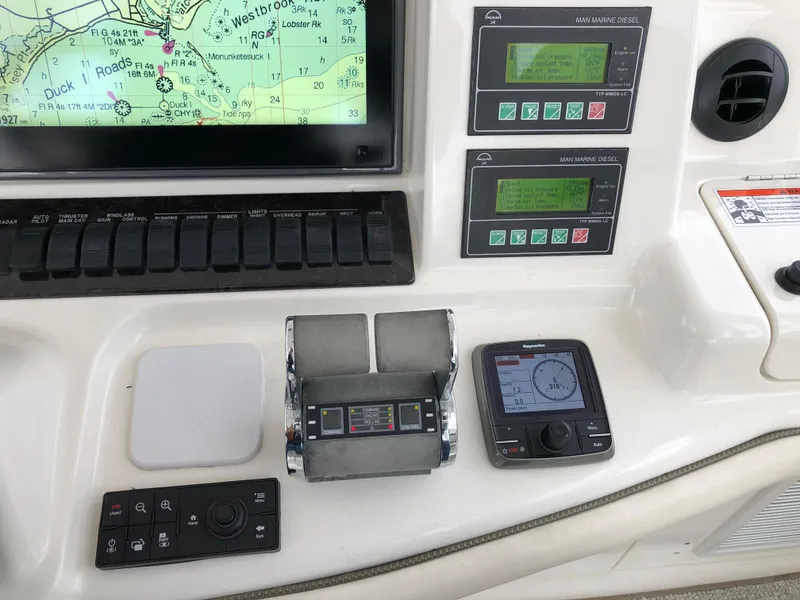 Slide: The Image of Control panel of a 2006 Sea Ray 52 Sedan Bridge yacht with navigation and engine displays. - 16