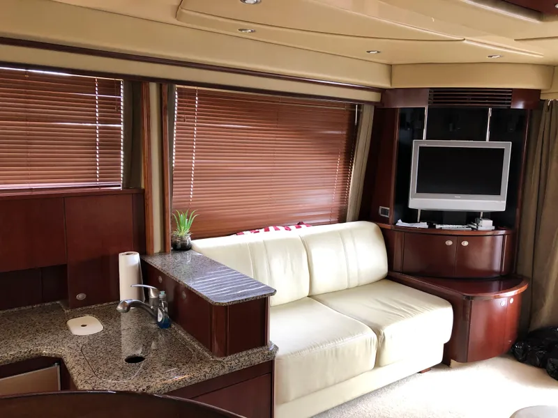 Slide: The Image of Interior of 2006 Sea Ray 52 Sedan Bridge with sofa, TV, and kitchenette. - 20