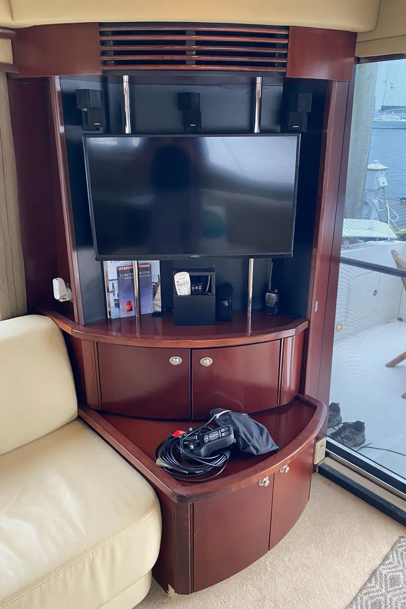 Slide: The Image of Entertainment center in 2006 Sea Ray 52 Sedan Bridge yacht with TV and storage cabinets. - 21