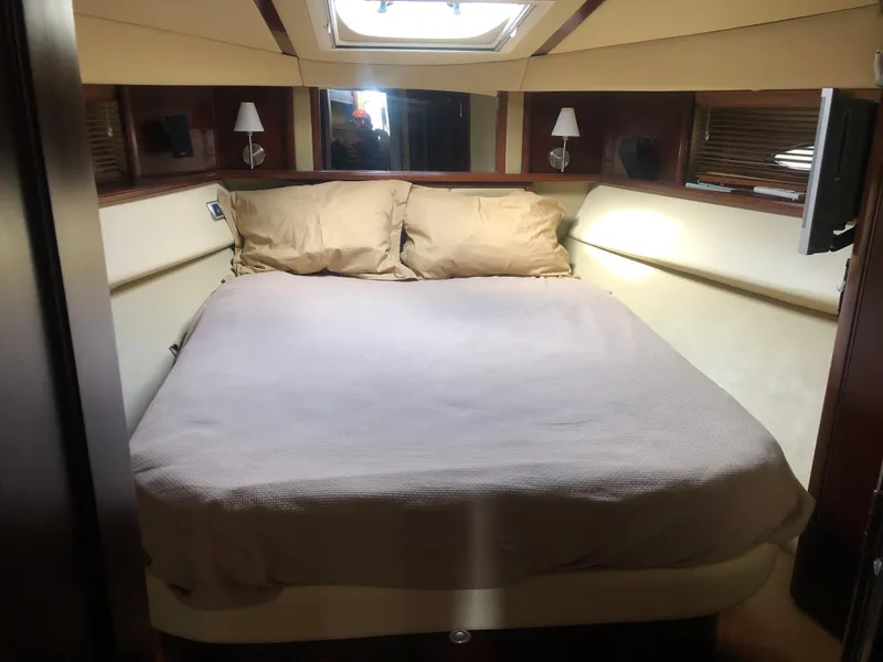 Slide: The Image of Luxurious bedroom in 2006 Sea Ray 52 Sedan Bridge yacht with skylight and cozy bedding. - 29