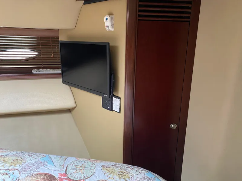 Slide: The Image of Interior cabin of 2006 Sea Ray 52 Sedan Bridge with mounted TV and wooden door. - 30