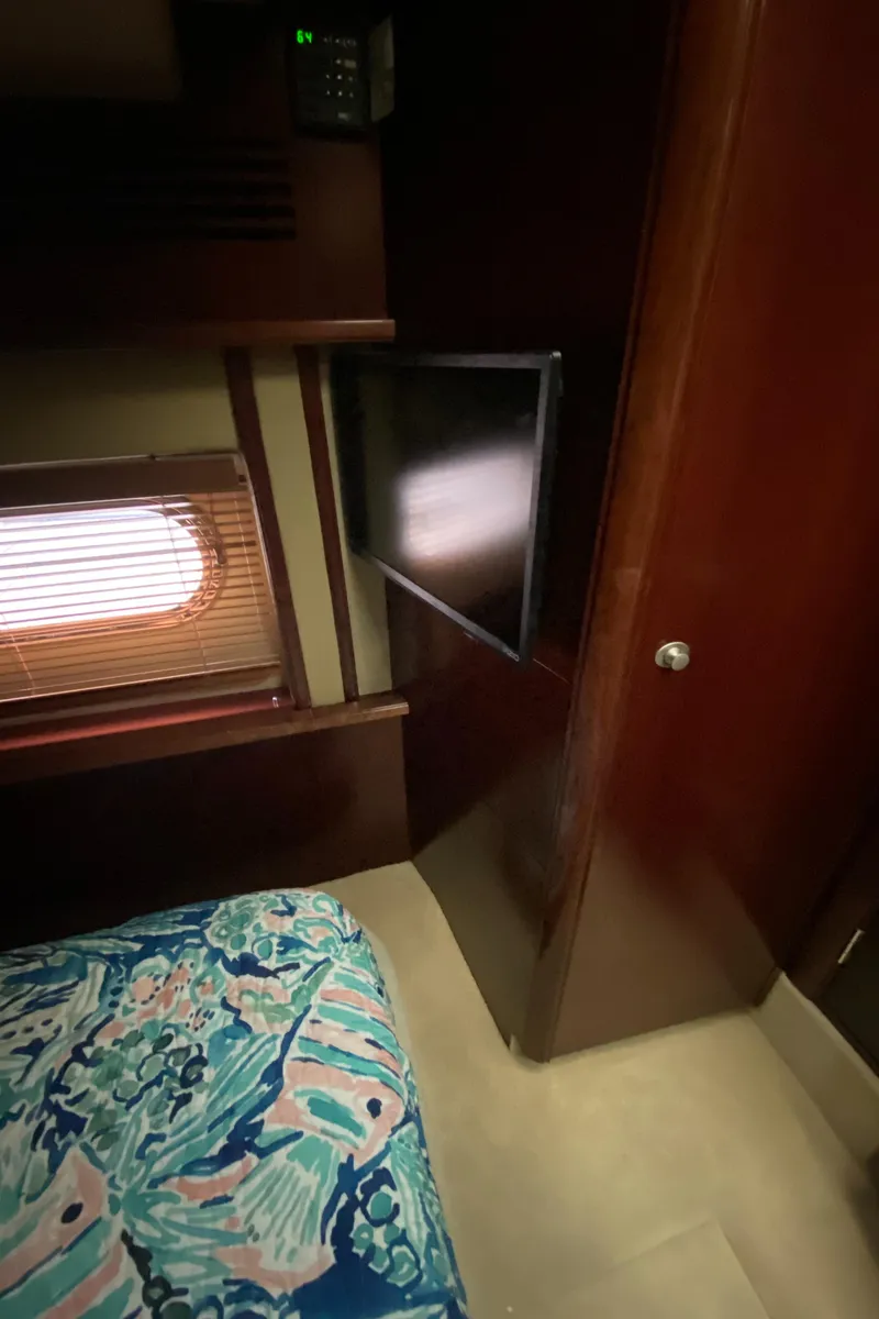 Slide: The Image of 2006 Sea Ray 52 Sedan Bridge cabin interior with TV and window. - 32