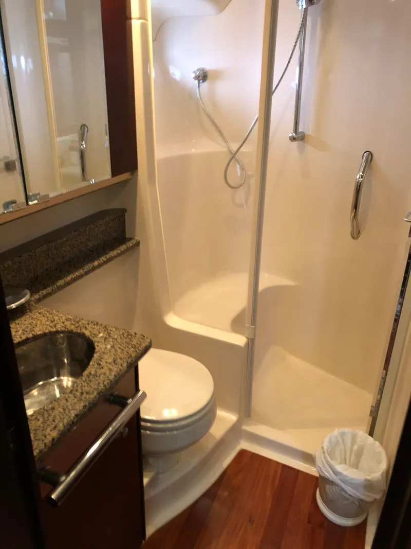 Slide: The Image of 2006 Sea Ray 52 Sedan Bridge bathroom with shower, sink, and toilet. - 34