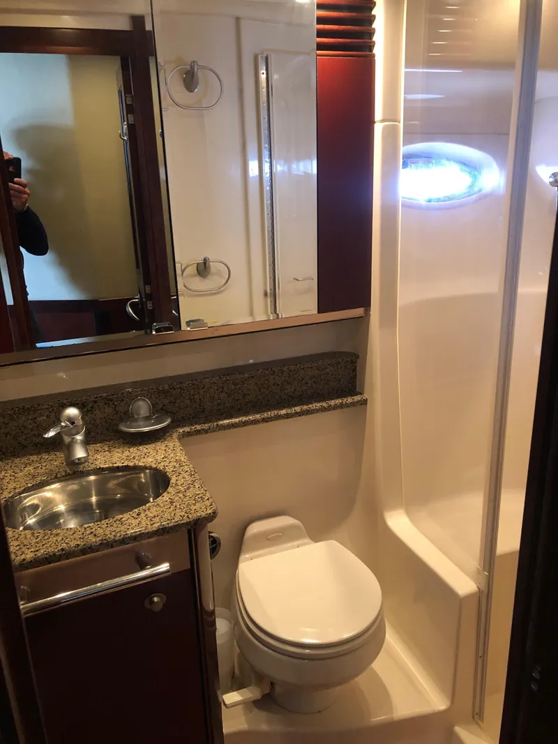 Slide: The Image of 2006 Sea Ray 52 Sedan Bridge bathroom with sink, toilet, and shower. - 35