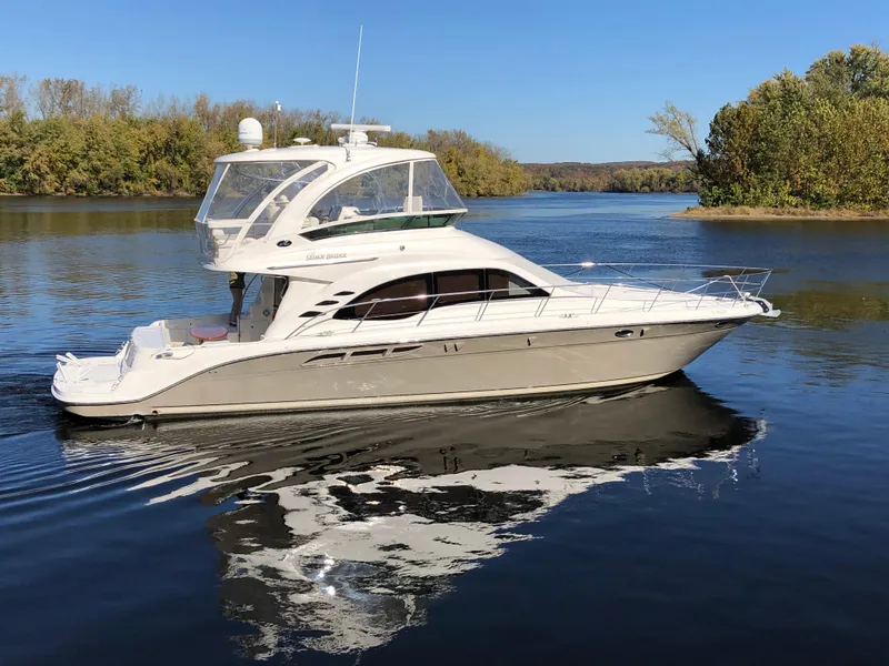 Slide: The Image of 2006 Sea Ray 52 Sedan Bridge yacht cruising on a calm lake. - 4