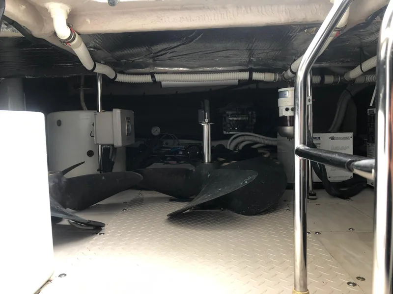 Slide: The Image of Engine room of a 2006 Sea Ray 52 Sedan Bridge yacht with visible propellers and equipment. - 48